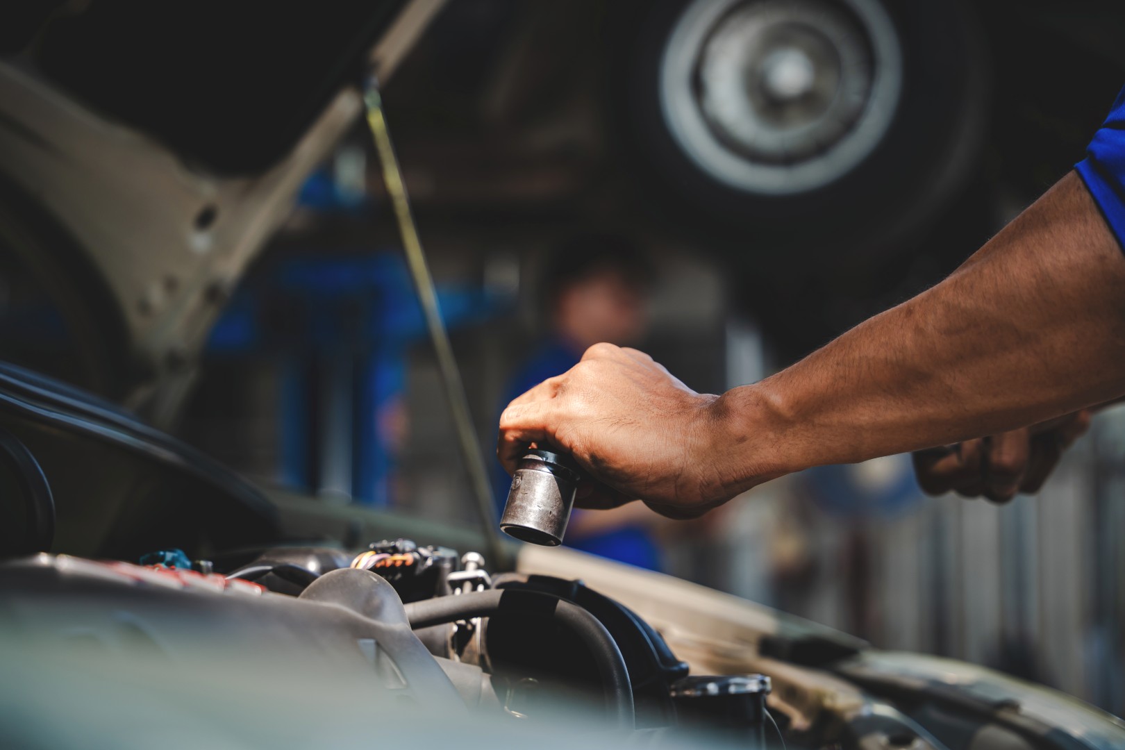 Mechanic inspects and maintains the engine for the customer.